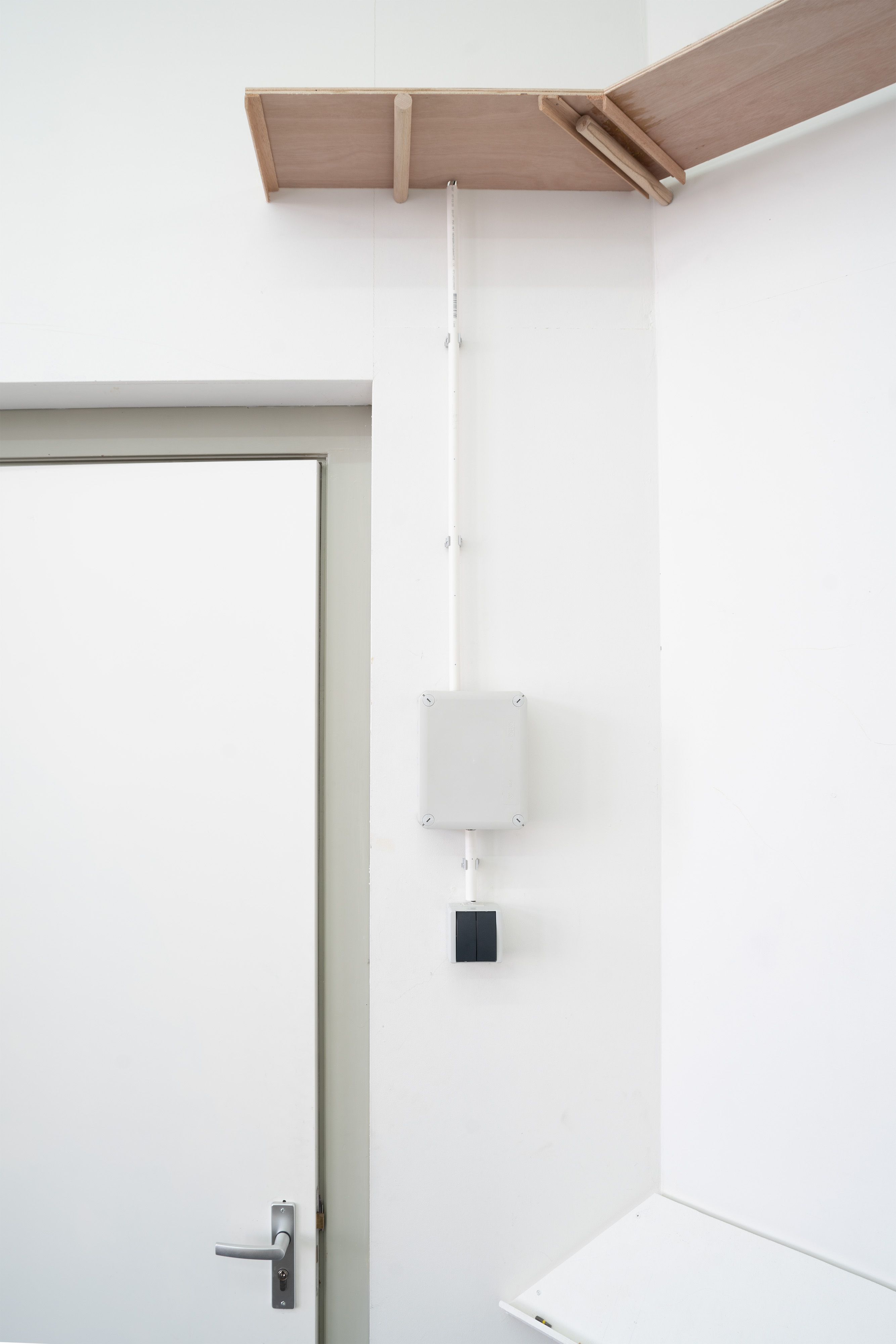 Marissa Lee Benedict and David Rueter, a conversation between machines about Mallarmé (regarding the state of the gallery lights), 2023, Wooden shelf, receipt printer, thermal paper, wiring and conduit, custom software, annotated text file containing Stéphane Mallarmé's poem "Un coup de dés jamais n'abolira le hasard," Large Language Model (LLM) cloud service account, single-board computer., Dimensions Variable