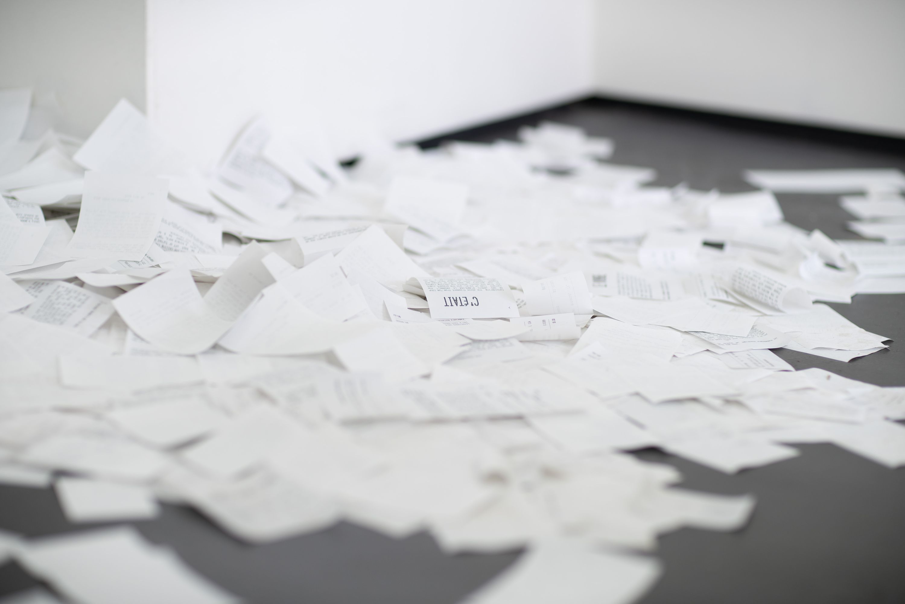 Marissa Lee Benedict and David Rueter, a conversation between machines about Mallarmé (regarding the state of the gallery lights), 2023, Wooden shelf, receipt printer, thermal paper, wiring and conduit, custom software, annotated text file containing Stéphane Mallarmé's poem "Un coup de dés jamais n'abolira le hasard," Large Language Model (LLM) cloud service account, single-board computer., Dimensions Variable